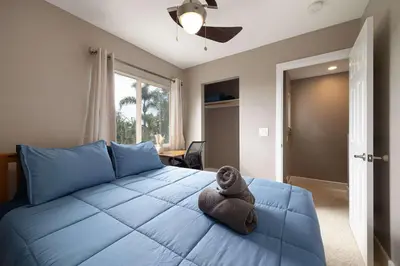 a bedroom with a blue bed with a stuffed animal on it at Central Location Gym Hot Tub Villa in San Diego