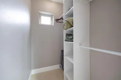 a walk in closet with white walls and a window at Central Location Gym Hot Tub Villa in San Diego