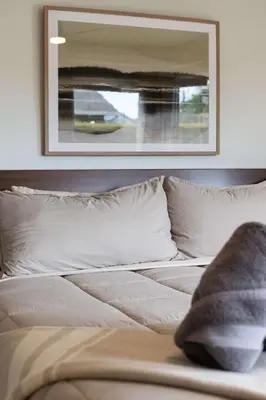 a bed with white pillows and a picture on the wall at Central Location Gym Hot Tub Villa in San Diego