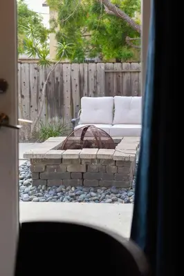a fire pit with two white couches in a backyard at Central Location Gym Hot Tub Villa in San Diego