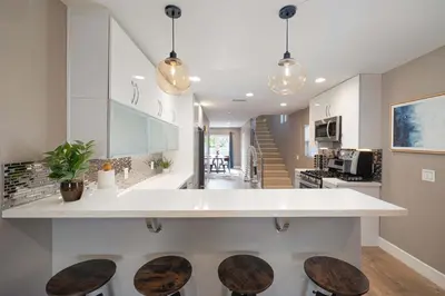 a kitchen with a counter and some stools at Central Location Gym Hot Tub Villa in San Diego
