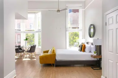 a bedroom with a bed and a table and chairs at Gaslamp Loft Escape Sleeps 7 in Style in San Diego