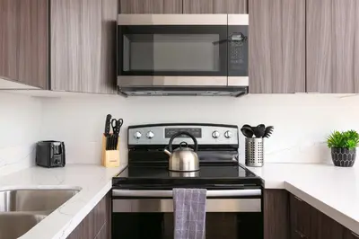a kitchen with a stove with a tea kettle on it at Gaslamp Loft Escape Sleeps 7 in Style in San Diego