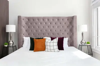 a bedroom with a large white bed with colorful pillows at Bright 2BR Loft Sleeps 7 with Full Kitchen and Fast WiFi in San Diego
