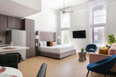 a bedroom with a bed and a living room at Bright 2BR Loft Sleeps 7 with Full Kitchen and Fast WiFi in San Diego