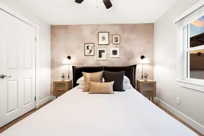 a bedroom with a large white bed and a window at Updated Historic Suite with Queen Bed and Kitchen in San Diego
