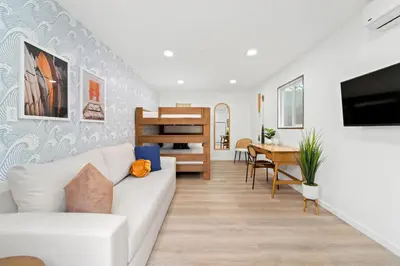 a living room with a white couch and a table at Spacious Group Getaway Games BBQ with Free Parking in San Diego