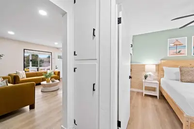 a bedroom with a bed and a living room at Spacious Group Getaway Games BBQ with Free Parking in San Diego