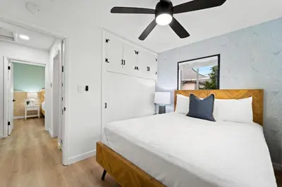 a bedroom with a bed and a ceiling fan at Spacious Group Getaway Games BBQ with Free Parking in San Diego