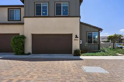a house with two garage doors on a brick driveway at Family home with Private Gym in Escondido