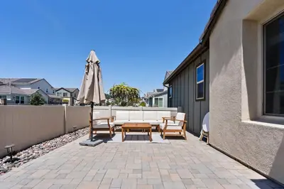 a patio with an umbrella and chairs and a table at Family home with Private Gym in Escondido