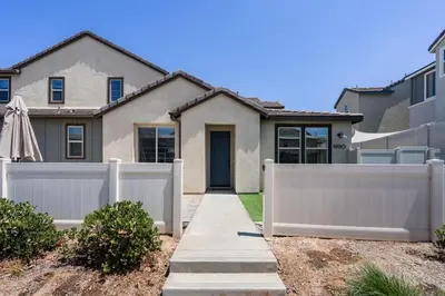 a white fence in front of a house at Family home with Private Gym in Escondido