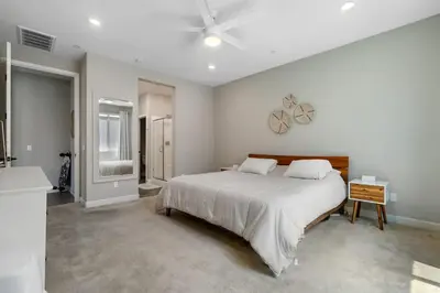 a bedroom with a large bed and a ceiling fan at Family home with Private Gym in Escondido