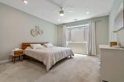a white bedroom with a bed and a window at Family home with Private Gym in Escondido