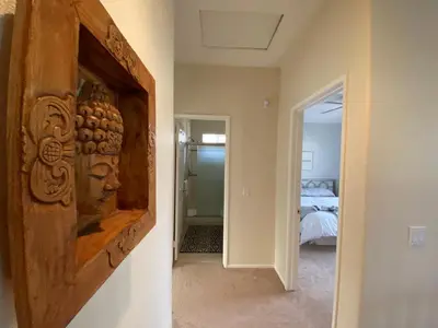 a hallway with a wall art of a head at Serene Beach Retreat in Encinitas