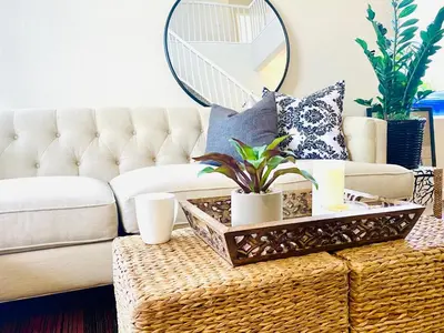 a living room with a couch and a rattan coffee table at Serene Beach Retreat in Encinitas