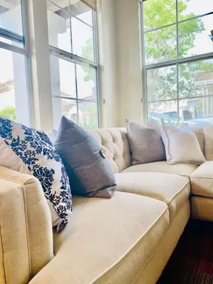 a couch in a living room with pillows on it at Serene Beach Retreat in Encinitas