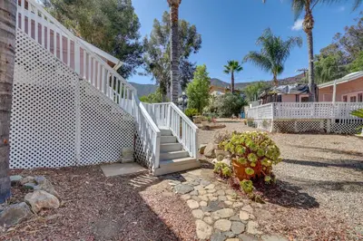 a white staircase leading up to a house with palm trees at 4 Mi to Shore Lake Elsinore Studio with Mtn Views in Lake Elsinore