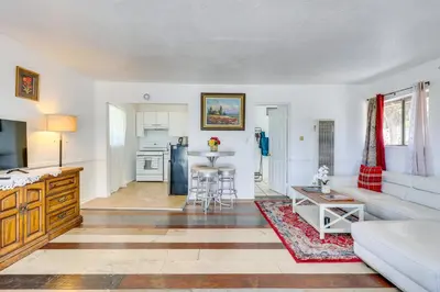 a living room with a couch and a table at 4 Mi to Shore Lake Elsinore Studio with Mtn Views in Lake Elsinore