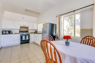 a kitchen with a table with a vase of flowers on it at Lake Elsinore Apt 4 Mi to Water Pets Welcome! in Lake Elsinore