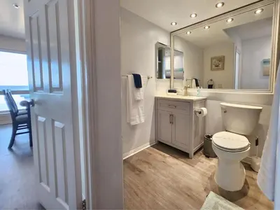 a bathroom with a toilet and a sink and a mirror at Modern Coastal Escape Breathtaking Ocean in Imperial Beach
