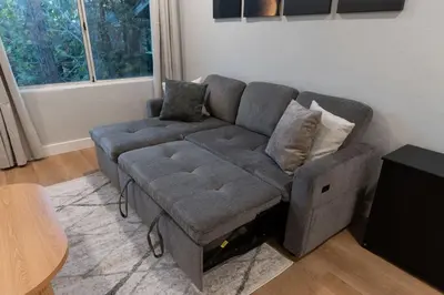 a grey couch in a living room with a window at Relaxing Retreat in North Park in San Diego