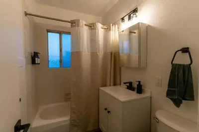 a bathroom with a sink and a shower curtain at Relaxing Retreat in North Park in San Diego