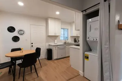 a kitchen with a table and a kitchen with white appliances at Relaxing Retreat in North Park in San Diego