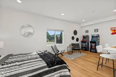 a bedroom with a bed and a table and chairs at Spacious Modern Farmhouse Retreat with Two Kitchens and Pool - Ideal for Large Groups and Families in Poway