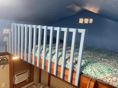 a bedroom with a staircase with a bed at Mystic Canyon Inn Bed & Breakfast in El Cajon