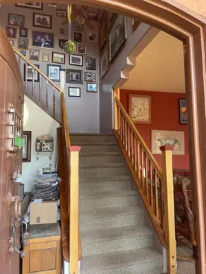 a staircase in a home with pictures on the wall at Mystic Canyon Inn Bed & Breakfast in El Cajon