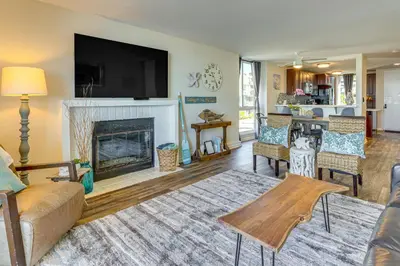 a living room with a fireplace and a tv at Steps to Shore Condo with Resort Perks in Oceanside in Oceanside