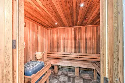 an empty wooden sauna with a bench in it at Steps to Shore Condo with Resort Perks in Oceanside in Oceanside