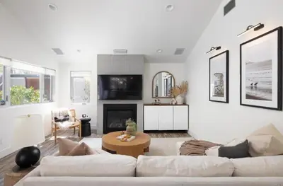 a white living room with a couch and a fireplace at Entire home in La Jolla, CA in San Diego