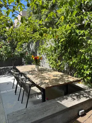 a wooden table with chairs and a vase of flowers on it at Entire home in La Jolla, CA in San Diego