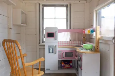 a small kitchen with a refrigerator and a table at The Vintage La Mesa Tudor in La Mesa