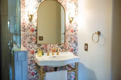 a bathroom with a sink and a mirror at The Vintage La Mesa Tudor in La Mesa