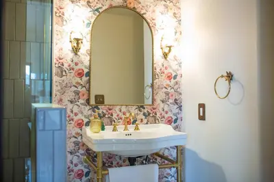 a bathroom with a sink and a mirror at The Vintage La Mesa Tudor in La Mesa