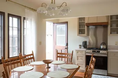 a kitchen with a table and chairs and a kitchen with a stove at The Vintage La Mesa Tudor in La Mesa