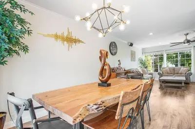 a dining room with a wooden table and chairs at Charming Villa with Backyard Oasis Close to Beach in Laguna Hills
