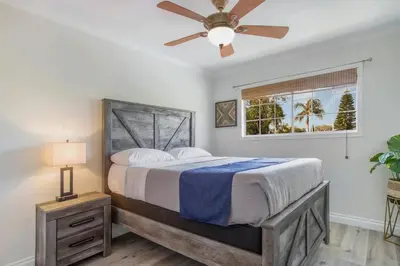 a bedroom with a bed and a ceiling fan at Charming Villa with Backyard Oasis Close to Beach in Laguna Hills