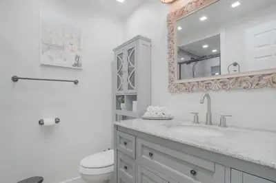 a bathroom with a sink and a toilet and a mirror at Charming Villa with Backyard Oasis Close to Beach in Laguna Hills