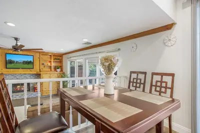 a dining room with a table and a vase with flowers at Charming Villa with Backyard Oasis Close to Beach in Laguna Hills
