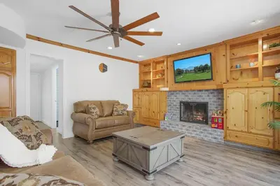 a living room with a couch and a fireplace at Charming Villa with Backyard Oasis Close to Beach in Laguna Hills