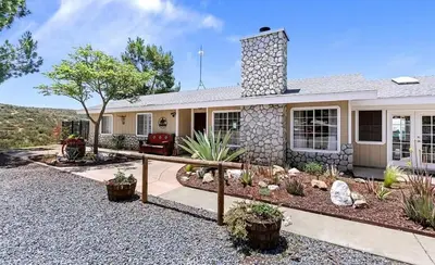 a house with a landscaping in front of it at Hilltop Getaway with Sunset Views in Temecula