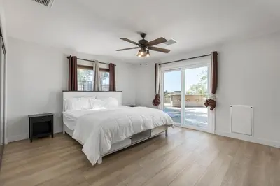 a white bedroom with a bed and a ceiling fan at Hilltop Getaway with Sunset Views in Temecula