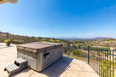 a barbecue grill sitting on a patio with a fence at Hilltop Getaway with Sunset Views in Temecula