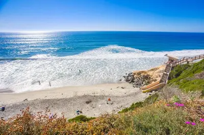 a staircase leading to a beach next to the ocean at Ocean 11 condo in Solana Beach