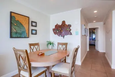 a dining room with a wooden table and chairs at Ocean 11 condo in Solana Beach