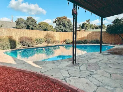 a swimming pool under a pavilion in a yard at Modern SD Oasis with Pool & HotTub in San Diego